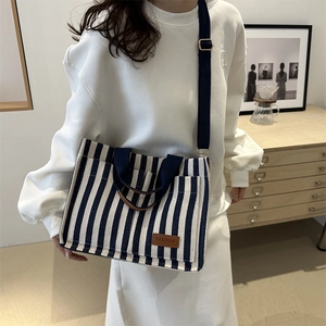 Blue and white striped canvas tote bag with long shoulder straps for daily commuting