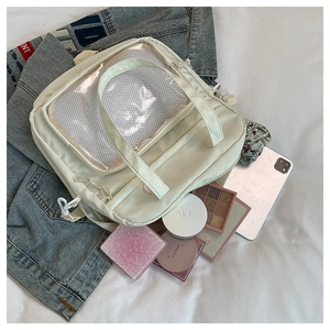 Vue détaillée du sac Ita crème avec fenêtre transparente montrant sa grande capacité