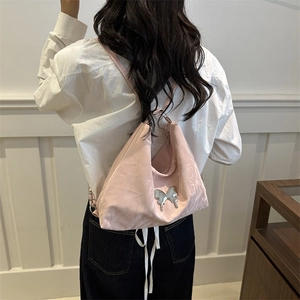 Stylish pink multi-way backpack with silver butterfly buckle shown on model back