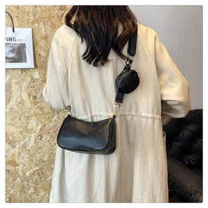 Detail of black crossbody bag set with small round coin purse and wide nylon strap