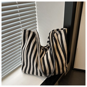 Detailed view of the woven vertical black and white stripes on this large canvas tote bag