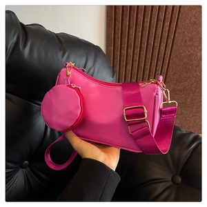 Detail of hot pink shoulder bag with wide strap and detachable small round coin purse