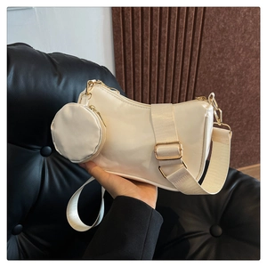 Creamy white 3-in-1 shoulder bag featuring a round coin purse and wide fabric strap