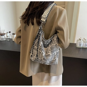 Detail shot of the black and white geometric knit texture and wide jacquard shoulder strap