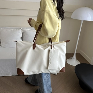 Large white waterproof Oxford tote bag with brown leather handles and small pouch