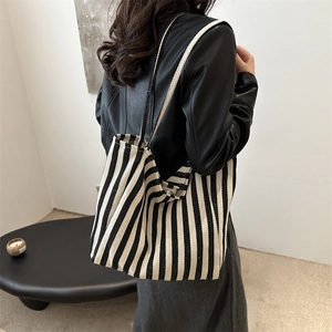 Minimalist black and white striped canvas tote bag with large capacity and woven handles