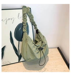 Detailed view of matcha green nylon ruched bag with a stylish scrunchie shoulder strap