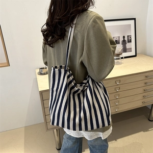 Minimalist striped canvas tote bag in navy blue and cream with large capacity for shoulder wear