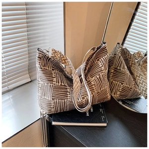 Detailed view of heavy jacquard fabric texture on a large capacity geometric tote bag