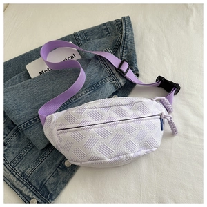 Detail of lavender woven chest bag showing 3D texture and purple nylon strap buckle