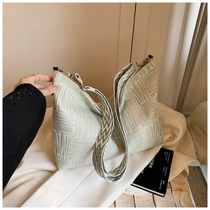 Detail of mint green jacquard tote bag with textured fabric and zig-zag woven strap