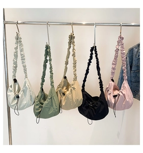 Detailed row of ruched strap nylon shoulder bags in beige, green, khaki, black and pink