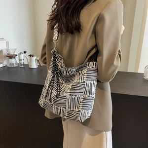 Large black and white plaid canvas tote bag with wide strap and tassel for daily commute