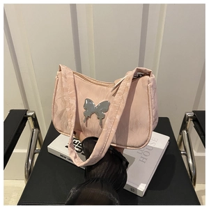 Close-up of pink ruched shoulder bag with a metallic silver butterfly buckle detail