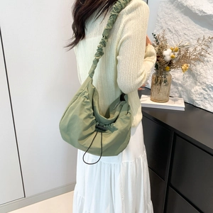 Olive green nylon ruched crossbody bag with adjustable drawstring and wide shoulder strap