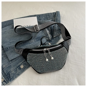 Close-up of sparkling light blue rhinestones and pearl zipper pull on black chest bag