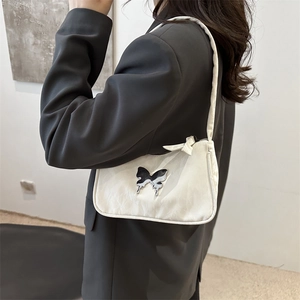 White ruched underarm shoulder bag featuring a metallic silver butterfly ornament for women