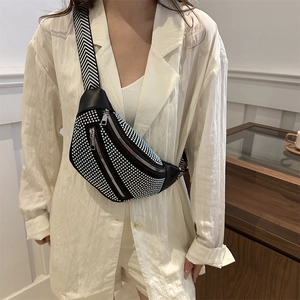 Fashionable black waist bag with sparkling silver rhinestones and woven strap worn by model