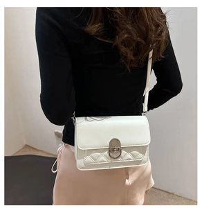 White faux leather crossbody bag with quilted stitching detail shown on model side view