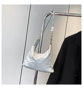 Detail of silver metallic hobo bag with pleated texture and beaded shoulder strap