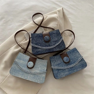 Fashionable denim chain crossbody bag in dark, medium, and light blue vintage texture