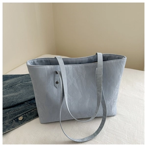 Close-up of light blue tote bag showing its unique wrinkled texture and dual slim straps