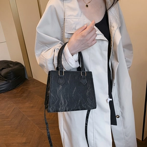 Chic black textured PU leather handbag with gold hardware for women, crossbody style