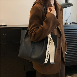 Classic black faux leather tote bag with stylish ribbon detail for autumn daily commute
