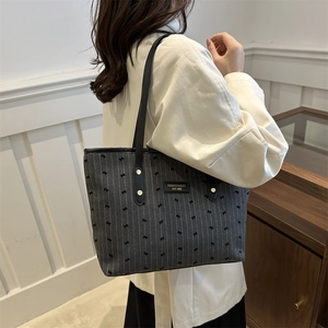 Sac fourre-tout chic en toile grise avec motifs nœuds et anses en cuir porté