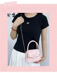 Detail of pink marble pattern mini bag with golden chain and magnetic flap closure