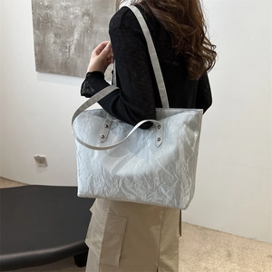 Silver-grey large capacity wrinkled tote bag with metallic studs for a modern minimalist look