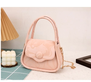 Detail of pink marble pattern bag with gold chain strap and round button closure