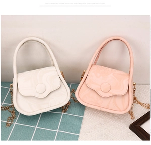 Detail of mini crossbody bags with marble texture in white and soft pink with gold chain