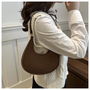 Brown crocodile embossed felt hobo bag on model with minimalist moon shape design