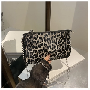 Close-up of leopard print small square bag with silver metal studs and chain strap