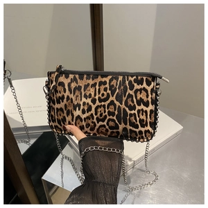 Close-up of leopard print PU leather bag featuring silver chain strap and metal rivets
