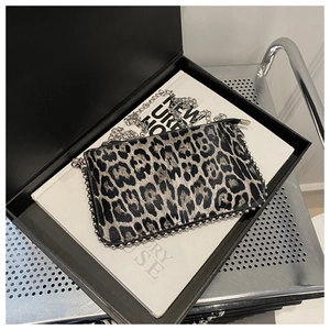Detail of leopard print crossbody bag with silver studs and chain strap in a gift box