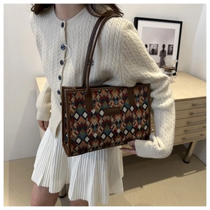 Detail of contrast jacquard tote bag with geometric pattern and leather handles