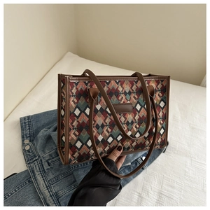 Close-up of Bohemian woven tote bag featuring colorful geometric patterns and leather handles