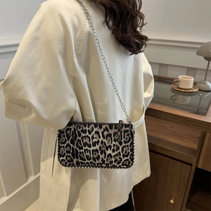 Fashionable leopard print crossbody bag with silver rivet details and a metal chain strap