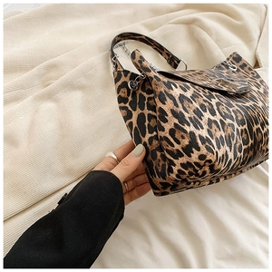 Close-up of leopard print handbag featuring metallic silver chain and buckle details