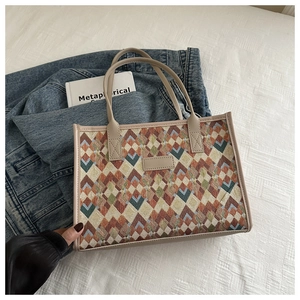 Detailed close-up of retro geometric rhombus pattern tote bag with beige leather accents