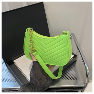 Detail of neon green chevron quilted bag with gold chain and matching shoulder strap