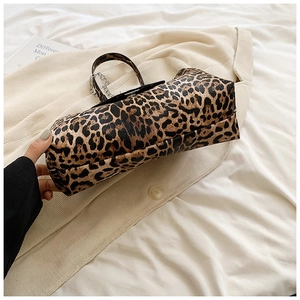 Detail of vintage leopard print crescent bag with silver chain and textured leather finish
