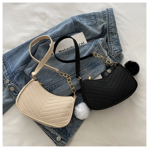 Detail view of quilted leather texture and golden chain strap on two stylish bags