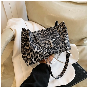 Detail of leopard print handbag featuring a silver T-logo and chic metal chain strap