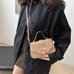 French vintage khaki leather crossbody bag with gold buckle shown on a model