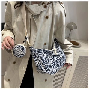 Detail of navy geometric canvas tote bag with a matching round coin purse on strap