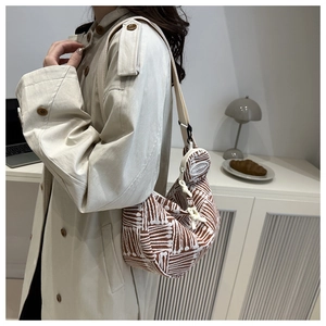 Detailed view of checkered knit hobo bag with wide strap and mini coin purse charm