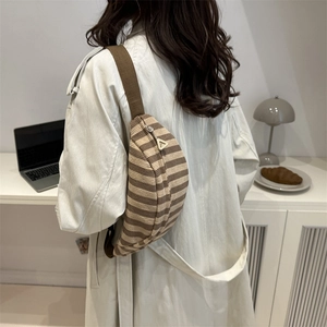 Brown striped corduroy crossbody chest bag for women in a minimalist indoor lifestyle setting